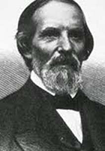 Retrato en blanco y negro de un hombre mayor con barba, vistiendo un traje formal del siglo XIX.