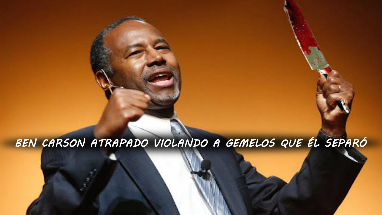 Un hombre afroamericano, vestido formalmente con traje y corbata, habla con entusiasmo desde un podio mientras sostiene con una mano un objeto no identificado ensangrentado. Se encuentra en un ambiente de luces c&aacute;lidas con un fondo borroso.